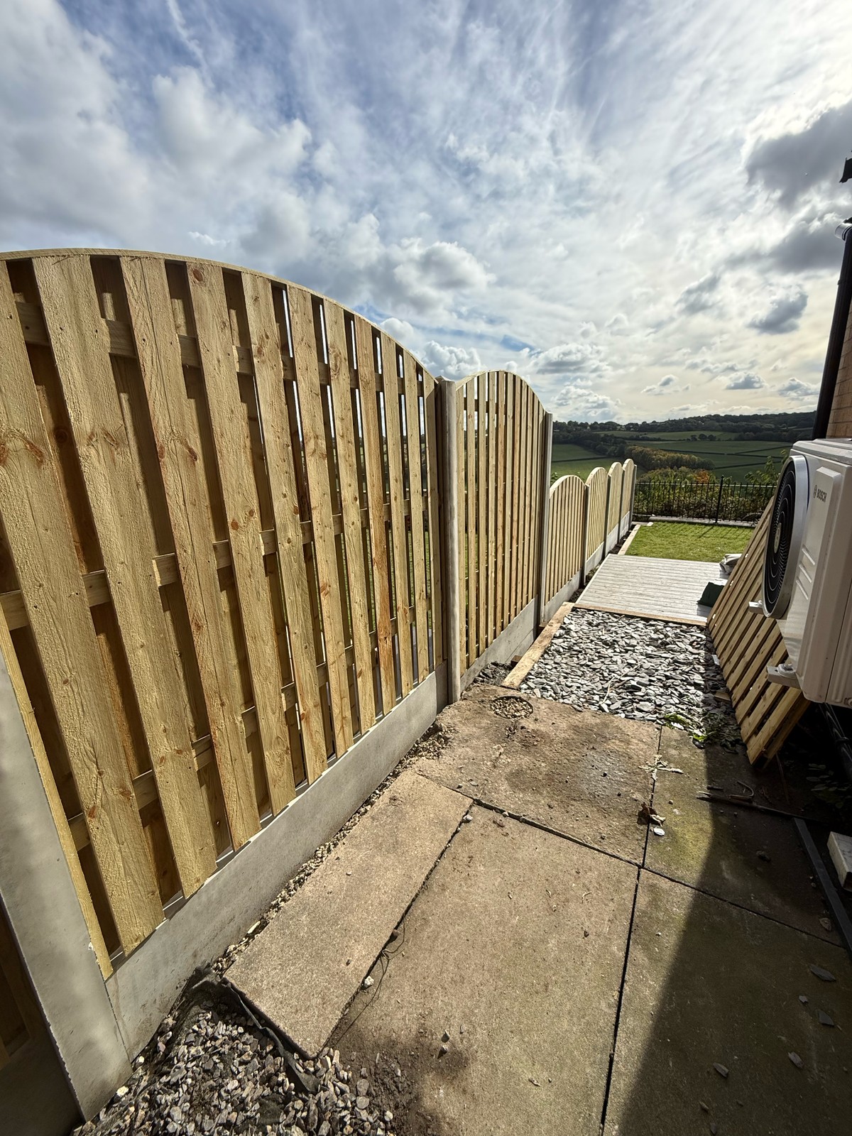 New curved-top palisade fence — after